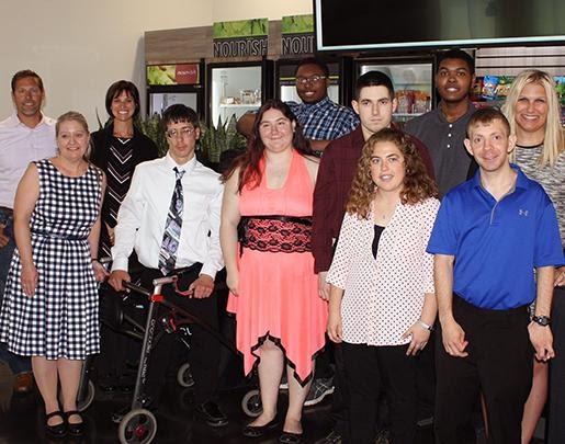 Large version of Laura and Matt Andis with a group of seven Project Search intern graduates and their two teachers standing together at graduation ceremony.